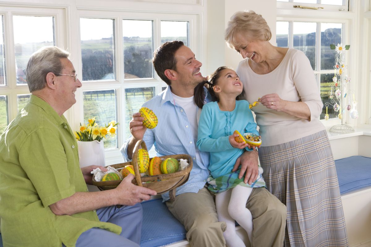Family enjoying healthy snacks together in bright kitchen setting with windows.